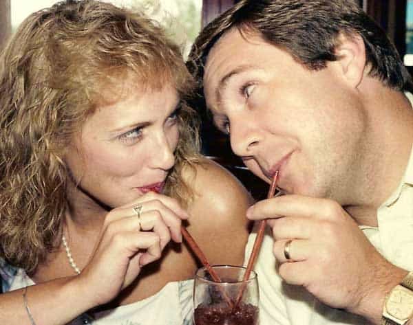 husband and wife sharing a drink each with a straw