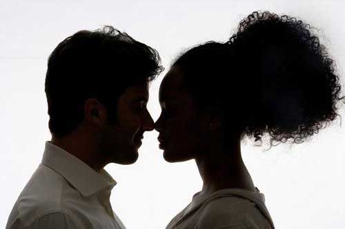 silhoutte of man and woman looking at each other