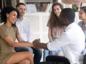 african american couple holding hands with other couples at marriage workshop